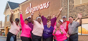 Staff waving in front of Wegmans.