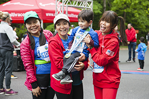 Three women, child and medals from Healthy Strides race.