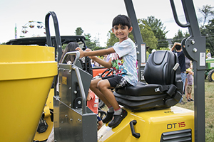 Boy sitting on a tractor.