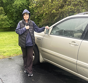 Debbie Frank beside Sue Rowell's car.