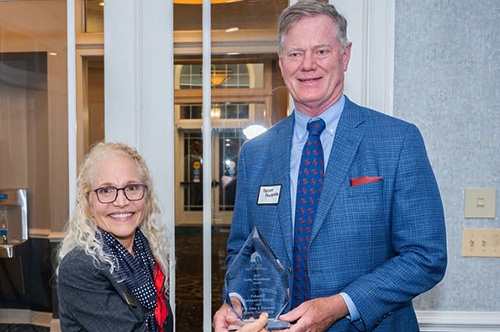 Man receiving Eakin Philanthropy Award.