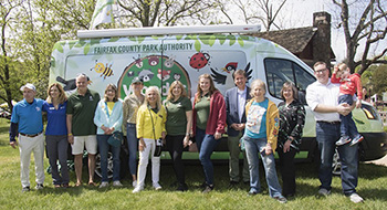 Gail Ruf and others stand in front of the Fairfax County Park Authority's Wonder Wagon.
